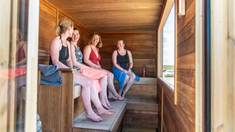 Visitors in the mobile sauna on the beach at Portstewart Strand, County Londonderry.
